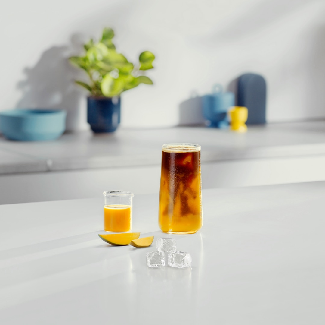 Iced Mango Grande Coffee next to ingredients