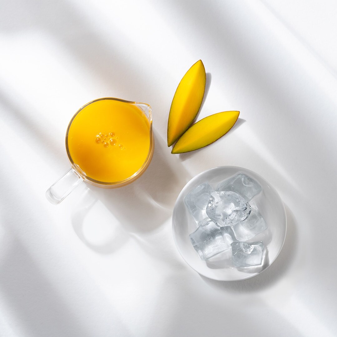 Iced Mango Grande Coffee next to ingredients