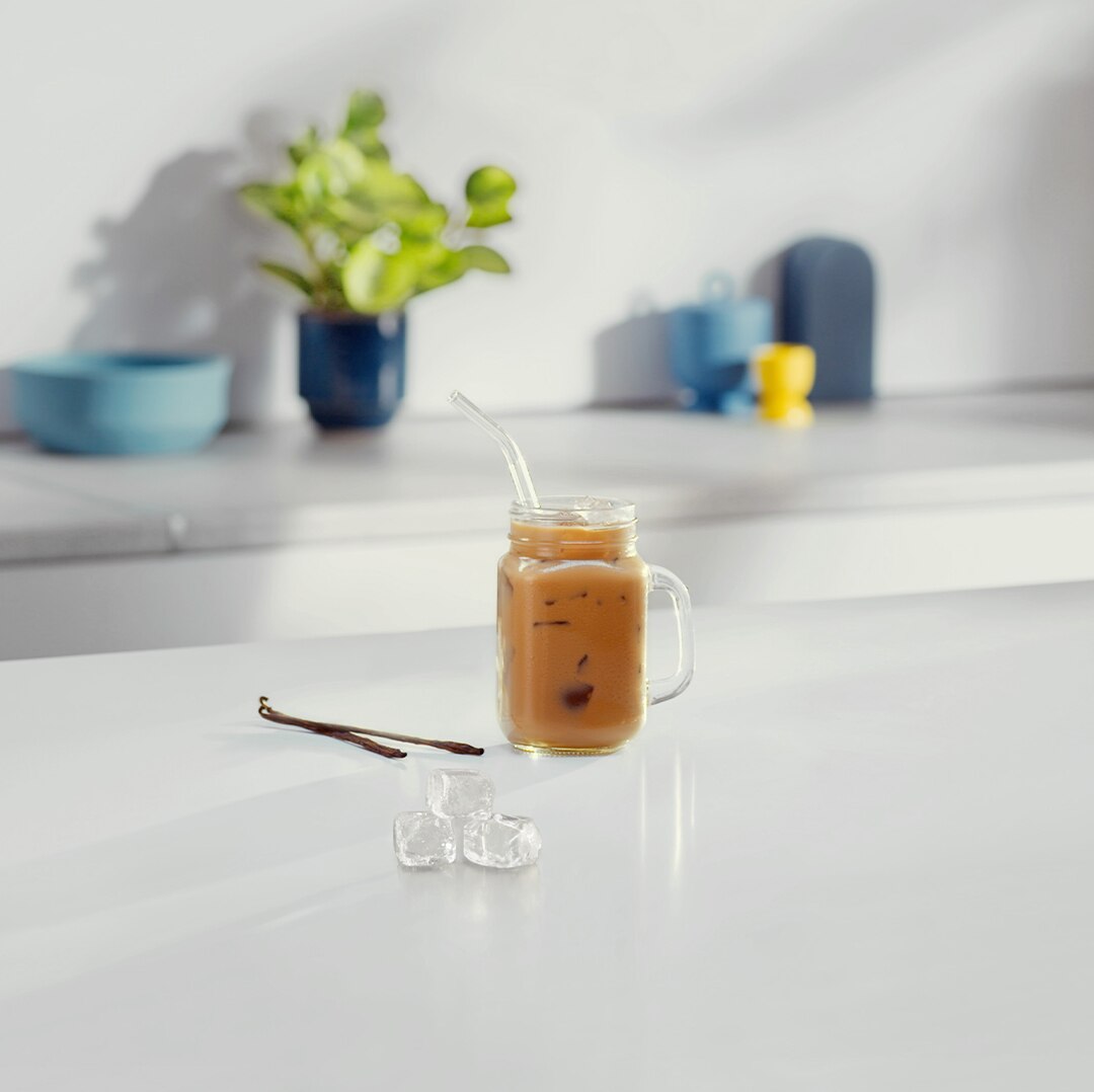 Iced Vanilla Café Au Lait next to ingredients