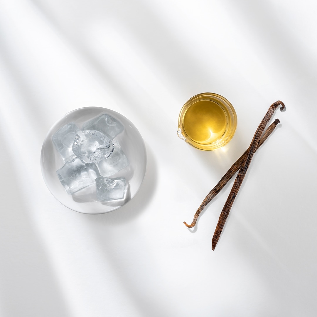 Iced Vanilla Café Au Lait next to ingredients